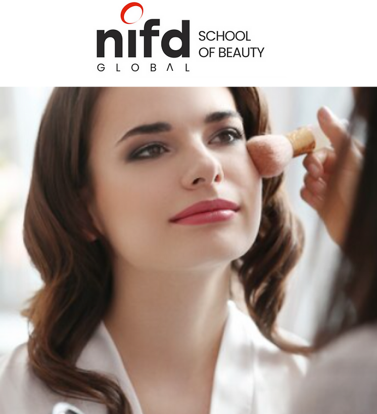 A woman with brown hair and red lipstick gets makeup applied with a brush, branded with the NIFD Global School of Beauty logo.